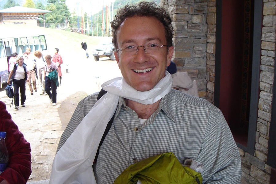 visitor wears bhutanese traditional scarf